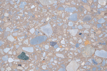 Poster - A background with a lot of different colored rocks scattered all over it. The rocks are of various sizes and colors, creating a visually interesting and unique pattern