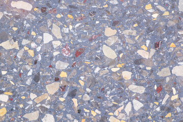 Poster - A background with a lot of different colored rocks scattered all over it. The rocks are of various sizes and colors, creating a visually interesting and unique pattern