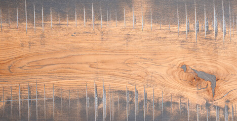 Poster - A wooden board with a grain pattern and a few holes. The board is brown and has a rustic feel