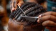 © familymedia - Detailed view of a hairstylist braiding hair with comb and scissors at hand, focusing on the hairstyle and tools