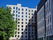 © Igor - The façade of an apartment building is being insulated at a construction site
