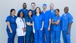 © Felippe Lopes - A diverse group of male and female healthcare professionals standing together confidently in blue uniforms, showcasing teamwork and unity.