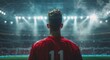 © olegganko - Soccer Player Stands in Empty Stadium Under Lights