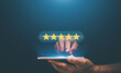 © krungchingpixs - Reputation and quality Concept. Businessman using smartphone to give five-star symbol for highest satisfaction, 5-star feedback, Standardization and quality in products and services. Excellent rank.