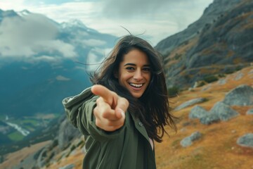 Sticker - A woman pointing at the camera while standing on a mountain. AI.