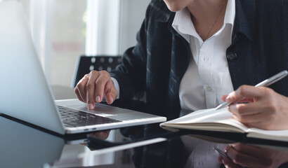 Sticker - Business woman working on laptop computer, planning work project and searching the information at office. Female student online studying and writing on paper notebook, e-learning, online study concept