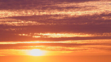 Wall Mural - Sunset is a beautiful view of the horizon, when the sunlight gives way to a colorful dusk with red clouds.