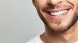 © Leli - A mans smile with white teeth against a grey backdrop