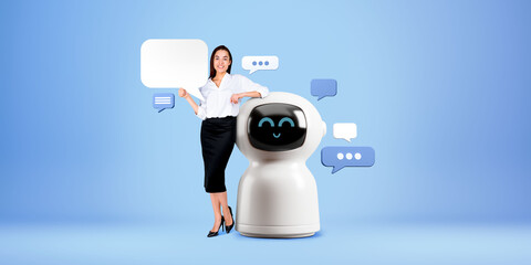 Poster - Businesswoman showing mock up speech bubble, standing near smiling robot