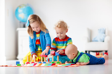 Wall Mural - Kids playing with wooden toy train