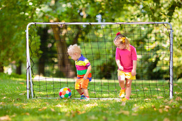 Sticker - Kids play football. Child at soccer field.