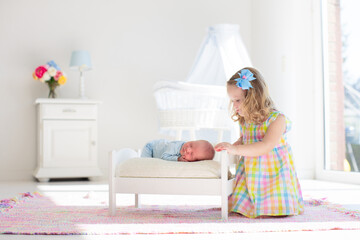 Wall Mural - Kids play with newborn baby brother