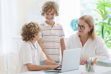 Wall Mural - Child in school. Student in class. Boy at homework