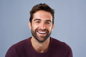 Fototapete - Happy, employee and face of man, studio and proud with career in media, creative and cheerful in New York. Blue background, portrait and confidence of journalist, person and staff in business of USA