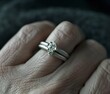 © Keattipoom - A hand holding a ring with three diamonds on it