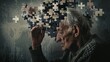 © Lakkhana - Conceptual scene of an elderly man reaching for a jigsaw puzzle of his portrait, with pieces missing or floating away, illustrating mental fragmentation.