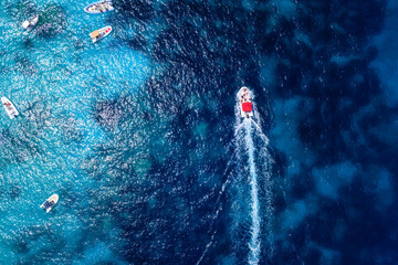 Wall Mural - aerial view on fast boat on blue sea at sunny day. vacation and leisure. fast ship on the sea surfac