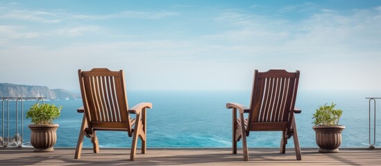 Aufkleber - A lovely set of chairs sit on the balcony overlooking the ocean, creating a tranquil spot with a serene view of the sea and copy space image.
