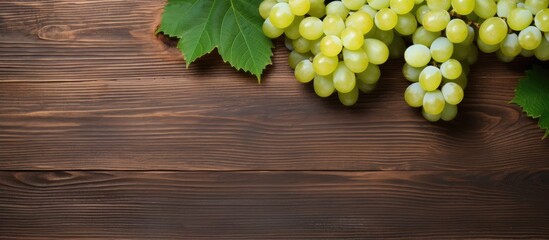 Poster - White table grapes on a rustic wooden background with copy space image.