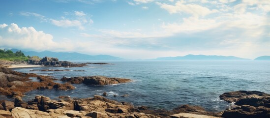 Poster - Scenic ocean landscape with rocks, clouds, and copy space image.