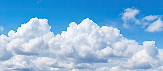 Poster - Beautiful puffy cumulus clouds against a blue sky;  copy space image.