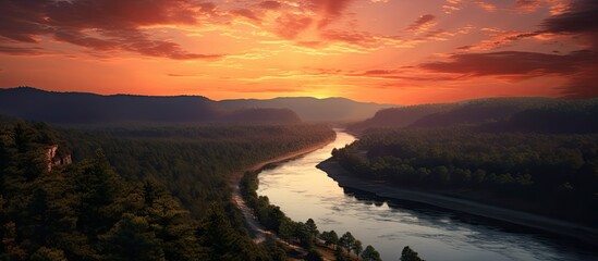 Poster - Scenic view overlooking a river, forest, and sunset with a red sky from a cliff with a mesmerizing landscape in the background, ideal for a copy space image.