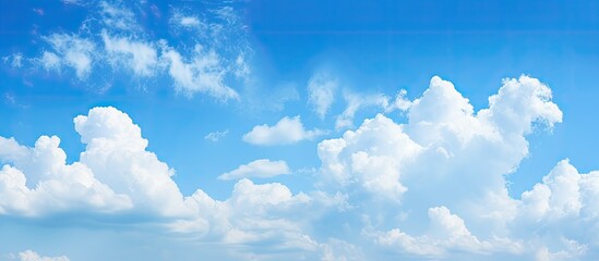 Aufkleber - Blue sky with fluffy clouds creating a serene atmosphere with ample copy space image.