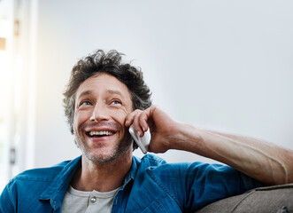 Poster - Man, home and happy on sofa with phone call for networking and communication. Living room, couch and smile for good news or conversations with fun, laugh and satisfied with connection to relax