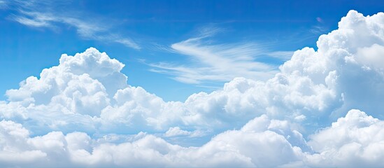 Poster - Scenic view of a clear blue sky complemented by fluffy white clouds in a copy space image.