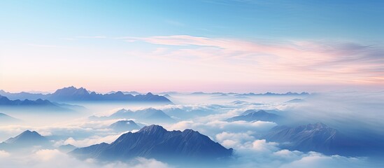 Poster - Mountains at sunrise above clouds, with a sea of clouds below, creating a picturesque landscape with copy space image.