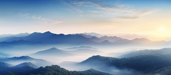Aufkleber - Scenic sunrise over mountains with morning mist, creating a captivating landscape with a scenic copy space image.