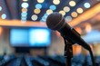 © darshika - Microphone over the Abstract blurred photo of conference hall or seminar room background