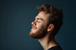 © MagnusCort - A close up of a man with beard and closed eyes looking to a side