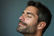 © MagnusCort - A close up of a man with beard and closed eyes looking to a side