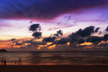 Wall Mural - Sunset over the water with clouds against the sunlight on the Andaman Sea, Patong, Phuket, Thailand.