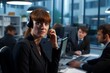 © alisaaa - portrait of female office worker using telephone headset in busy office