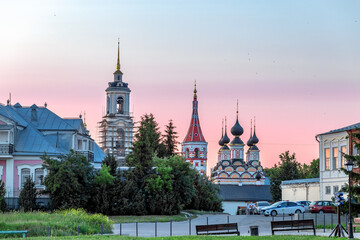 Wall Mural - Suzdal, Vladimir region, Russia, Golden Ring - Panorama view of the city at sunset. The bend of the river, and all the famous churches of the city: The Bell Tower of the Ordination Convent, Lazarevska