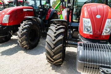 Wall Mural - Row of red agricultural tractors for sale.