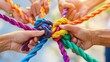 © Bijac - diverse hands holding colorful ropes teamwork and unity concept