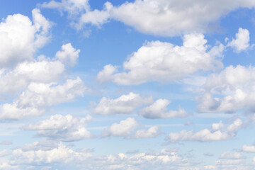Wall Mural - Beautiful light cloudy blue sky with many white fluffy cumulus clouds, background texture, heaven