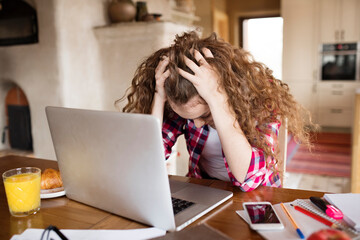 Wall Mural - A sad student get rejected from university, reading email. Hands in hair, unsuccess.