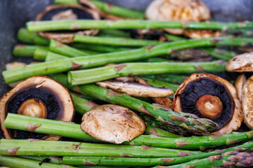 Wall Mural - green asparagus grilled with pieces of mushroom