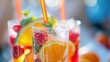 © Zaynab - A close-up of fruity mocktails with straws and ice, beautifully arranged on a sleek white table, perfect for a summer party.