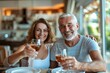 © Yuliia - Waist up photo of mature Caucasian couple raising a toast on their boat, signifying the cherished moments that are secured with boat insurance.