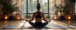 © gearstd - Woman meditating in a sunlit yoga studio