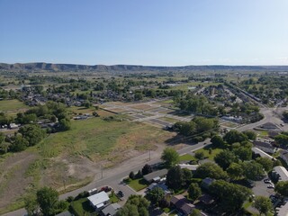 Wall Mural - aerial view of suburbs and mountain with trees and blue sky