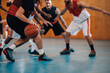 © Zamrznuti tonovi - Unrecognizable diverse team playing basketball at a gymnasium or a sports hall