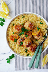 Canvas Print - Baked lemon butter chicken meatballs with creamy orzo.top veiw