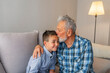 © Dragana Gordic - Grandfather kissing his grandson. Positive emotions. Gentle grandfather is hugging and kissing his grandson. Grandpa kissing grandson.
