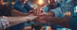 © Maxim Borbut - A stack of hands showing unity and teamwork against a panoramic, office background. Generative AI.